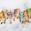 1751963415_81rH3Lvvk5S._SL1500_.jpg Ruby Kisses Broadway Vita-Lip Clear Lip Gloss (Mango Butter 6 Pack), Ultra-Hydrating & Soothing Formula with Multi-Vitamin Oils, High-Shine Non-Sticky Finish, Nourishing Glossy Lip Balm Softens Skin
